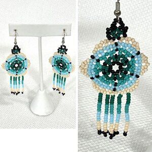 Handmade beaded huichol dangle earrings in blues and greens.